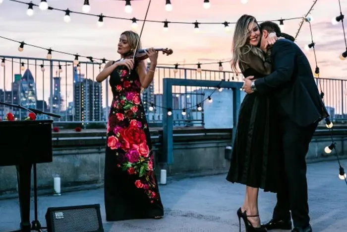 A styled proposal setup with florals and candlelight